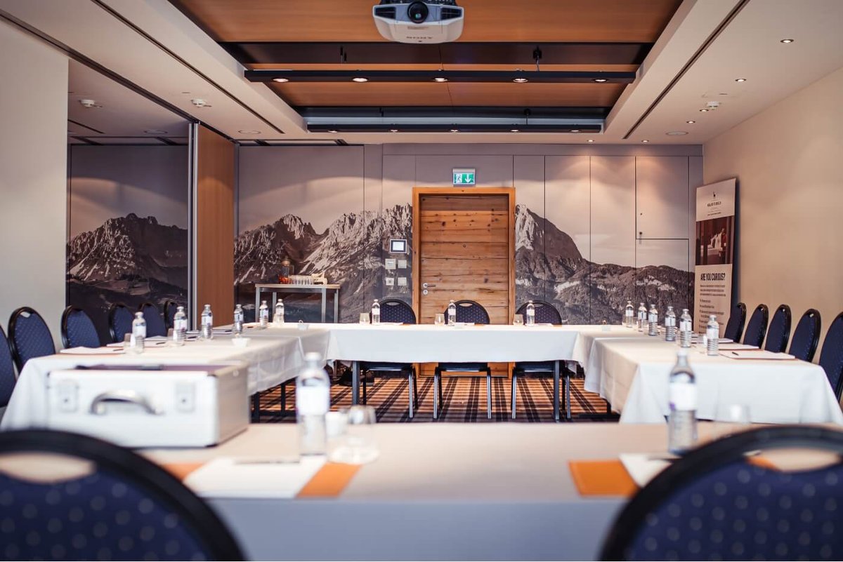 A meeting room with panoramic mountain wallpaper