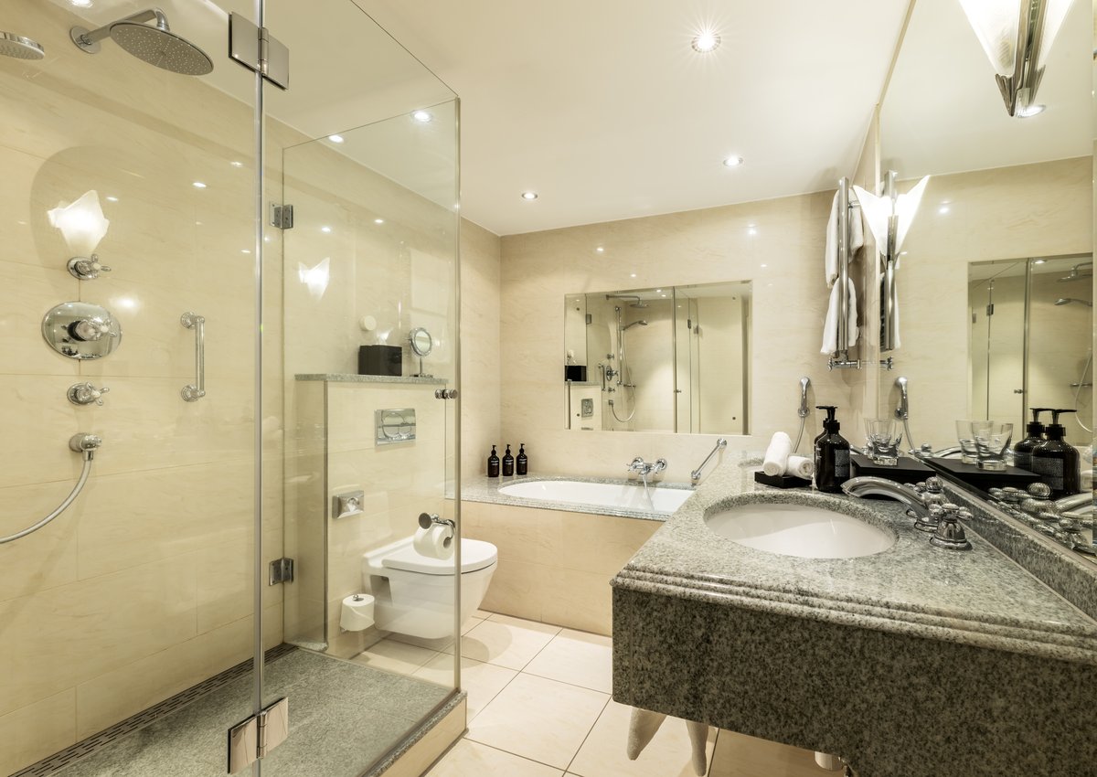 Glimpse into a large grey and white bathroom of a Signature Suite of the hotel