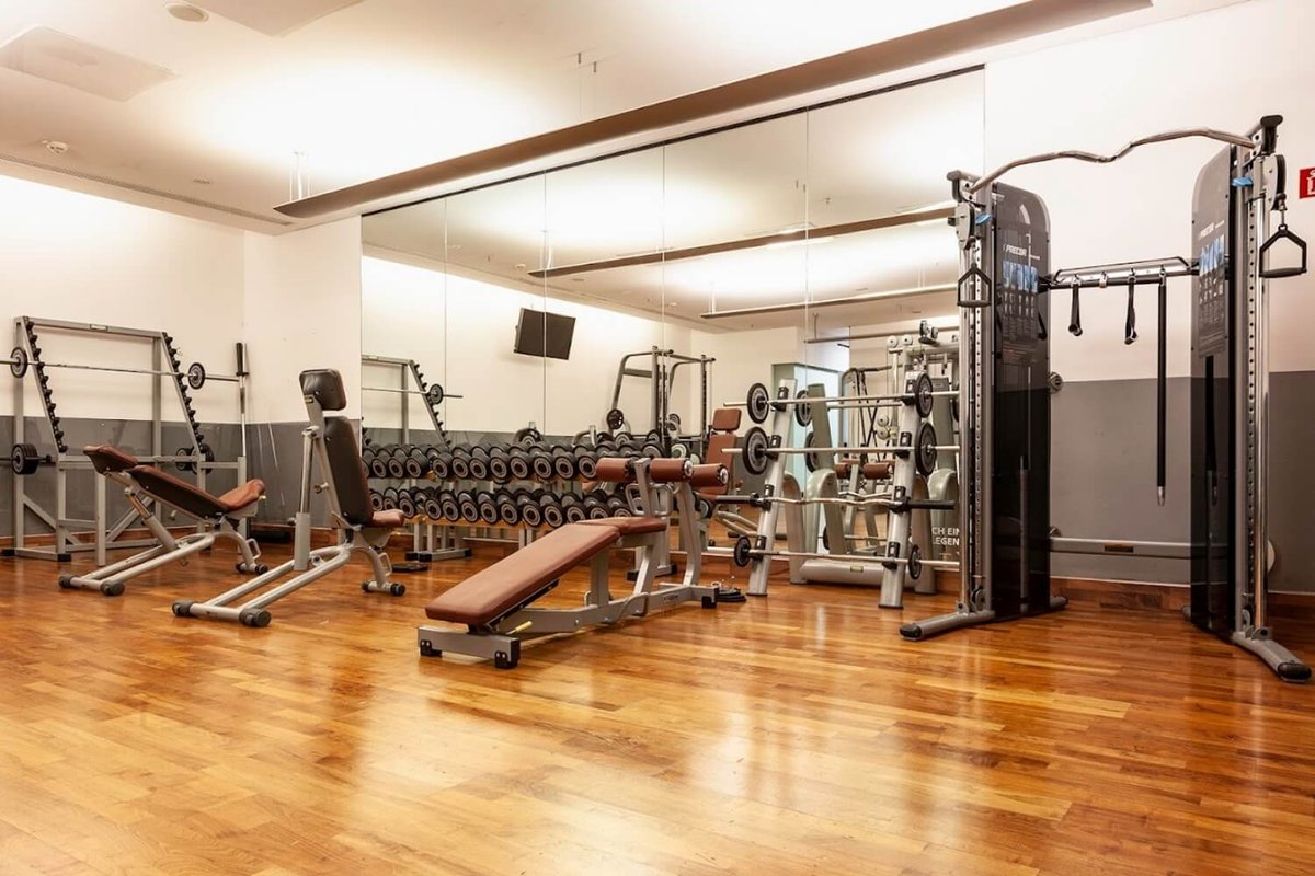 Insight into the fitness area with various machines and dumbbells