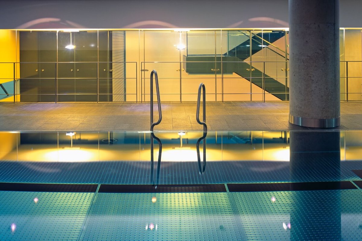 Photo of the illuminated indoor pool in the wellness area of the hotel