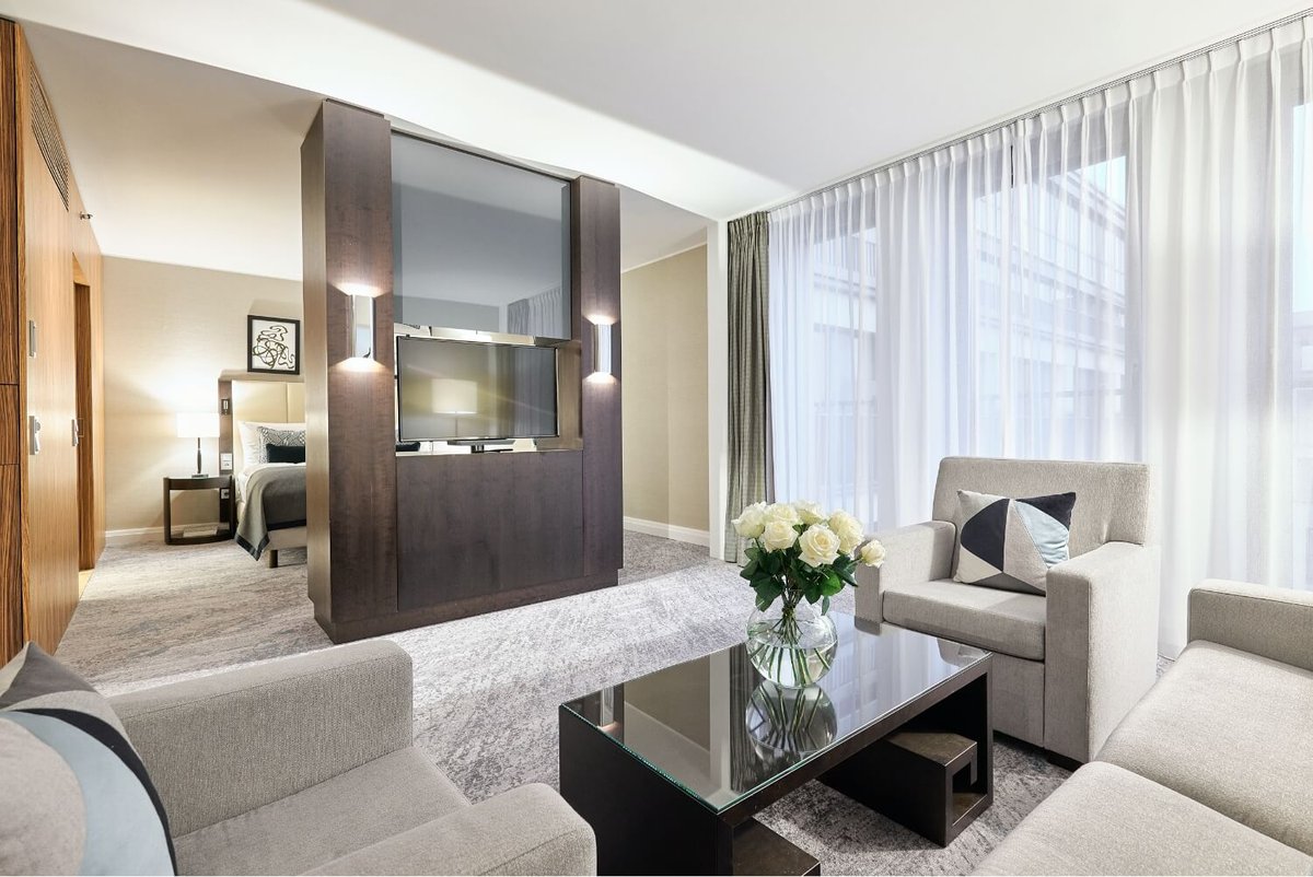 Insight into the modern living space of the Deluxe Suite, a hotel room in Dusseldorf
