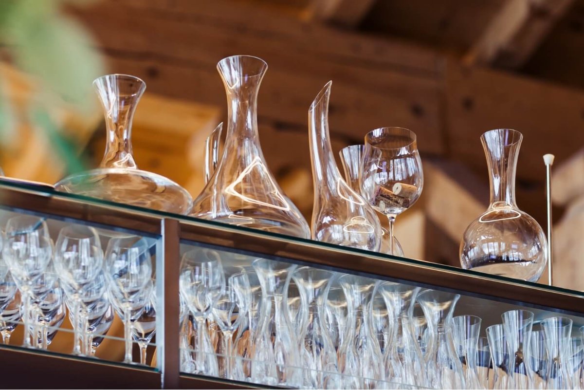 A shelf filled with wine glasses and decanters