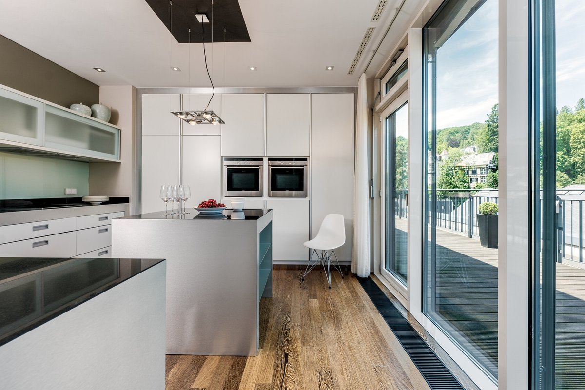 Die großzügige Küche mit Terrassezugang eines Penthouses des Hotels