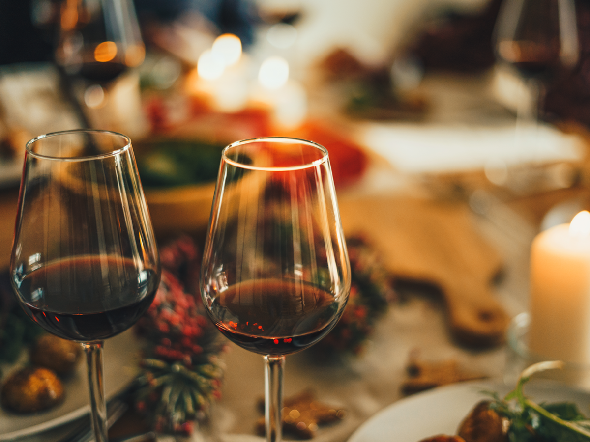 Two glasses of red wine on a Christmas decorated table