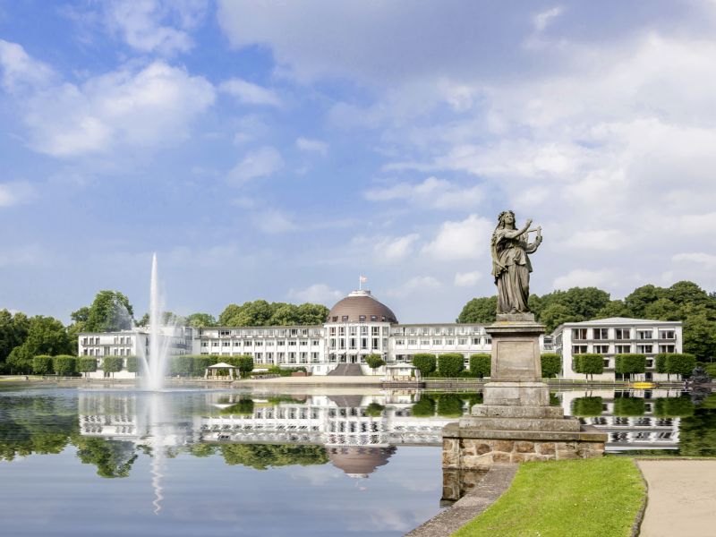 Außenansicht der Hochzeitslocation in Bremen hinter einem See mit Fontäne