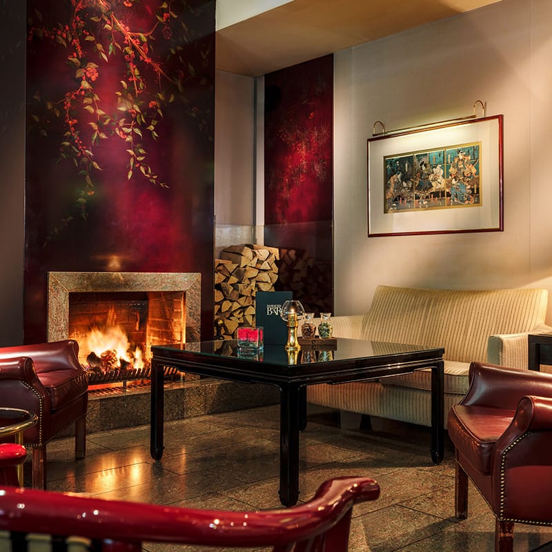 Shot from Nassauer Hof Bar with fireplace, red wallpaper and red leather armchairs