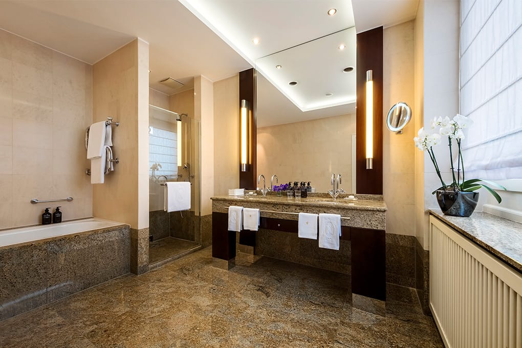 View of the bathroom with glass shower of an executive suite of the hotel