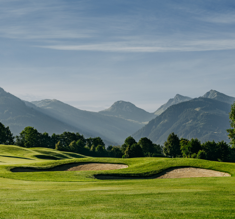 Golf course in front of the Kitzbühel Alps