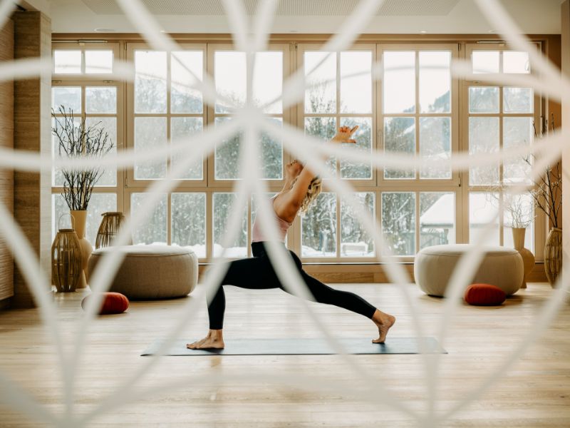 A woman doing yoga in a spa hotel in Kitzbühel